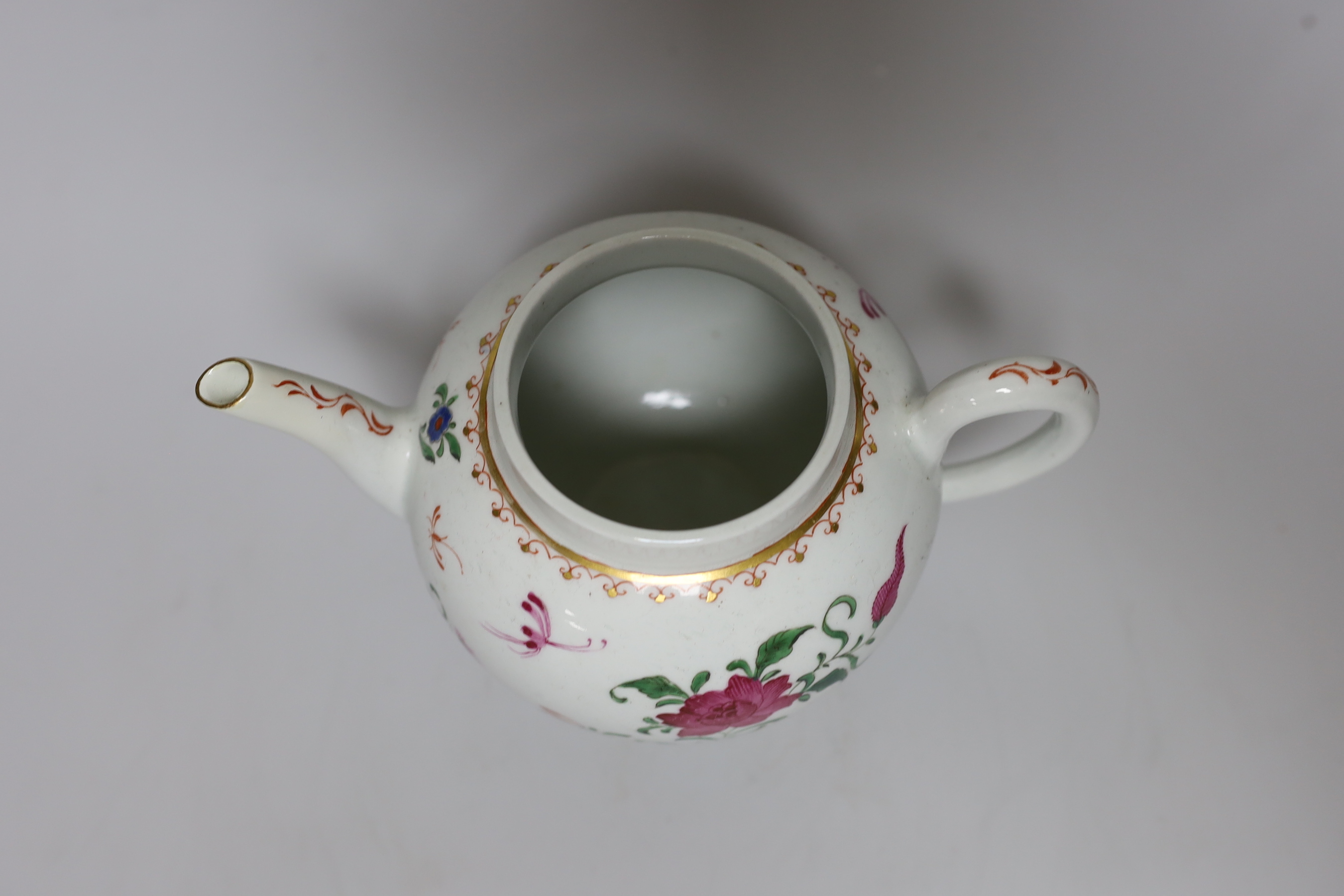 A Worcester teapot and cover, painted with Chinese style flowers and winged insects, c.1770, 14cm tall